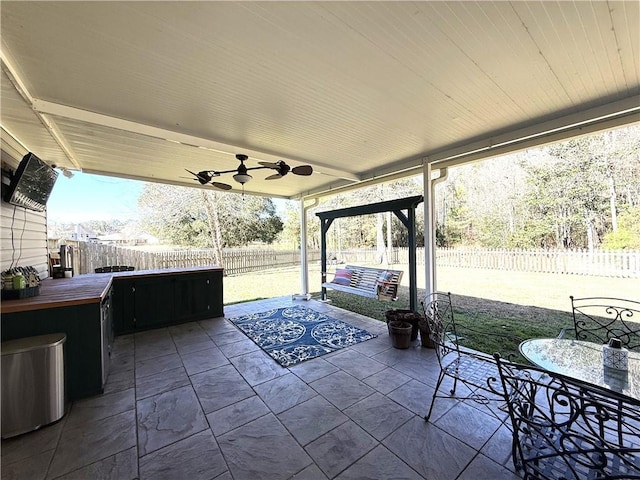 view of patio featuring outdoor dining area, a fenced backyard, ceiling fan, and outdoor lounge area