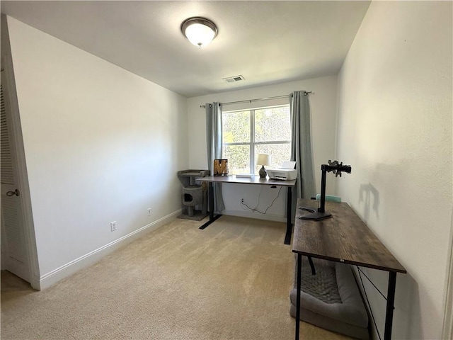 office space featuring light colored carpet, visible vents, and baseboards