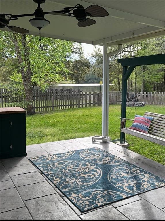 view of patio with fence and ceiling fan