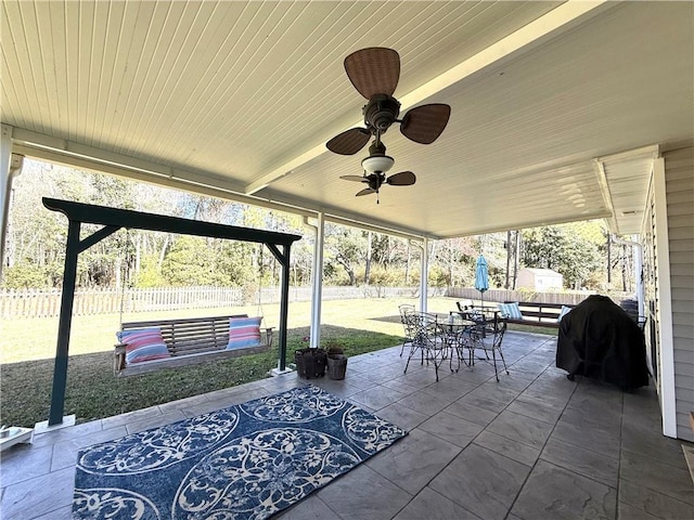 view of patio / terrace with a grill, outdoor dining area, fence, and a ceiling fan