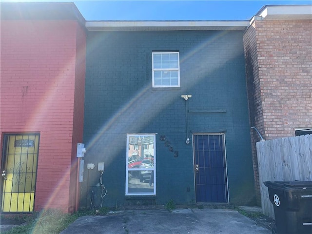 back of house with fence and brick siding