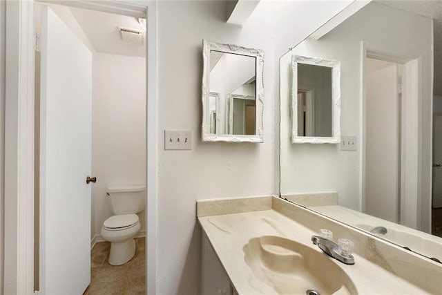 bathroom with visible vents, vanity, toilet, and tile patterned floors