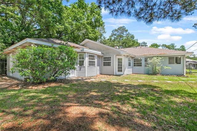 rear view of house with a yard