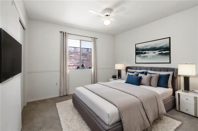 bedroom with ceiling fan, baseboards, and light colored carpet