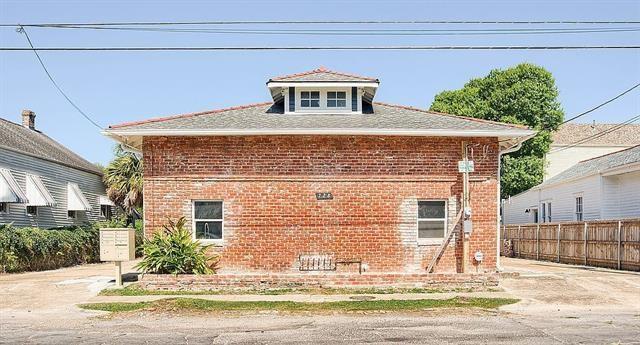 view of side of property with fence and brick siding