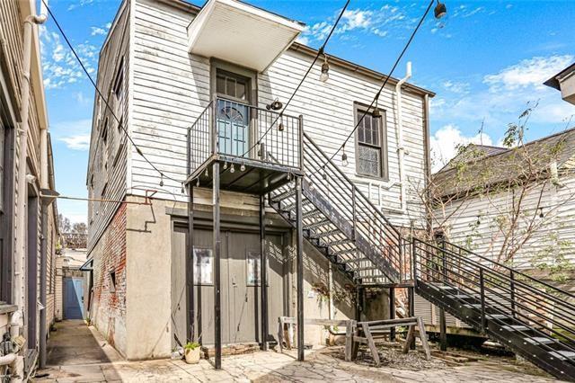 back of house featuring stairs