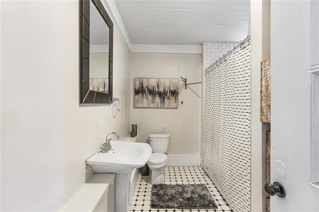 bathroom with toilet, tile patterned flooring, and a shower with shower curtain