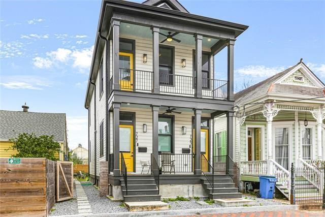 view of front of house featuring a porch, a balcony, a ceiling fan, and fence