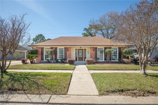 ranch-style house with brick siding and a front yard