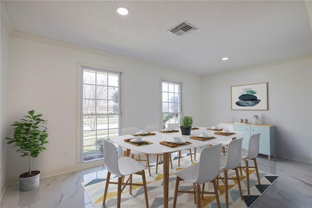 dining room with marble finish floor, crown molding, visible vents, and a textured ceiling