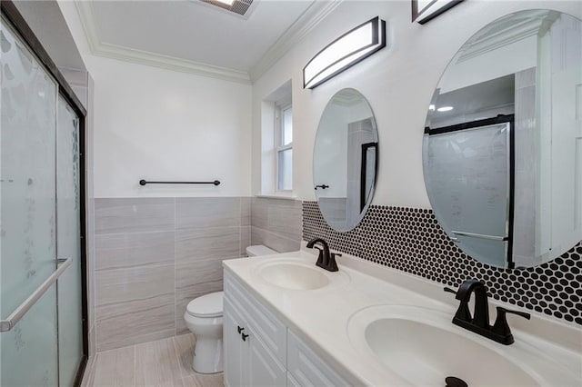 full bath with toilet, tile walls, a sink, and ornamental molding