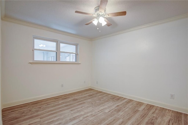 unfurnished room with light wood-style floors, crown molding, baseboards, and a ceiling fan