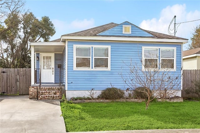 view of front of house featuring a front lawn and fence