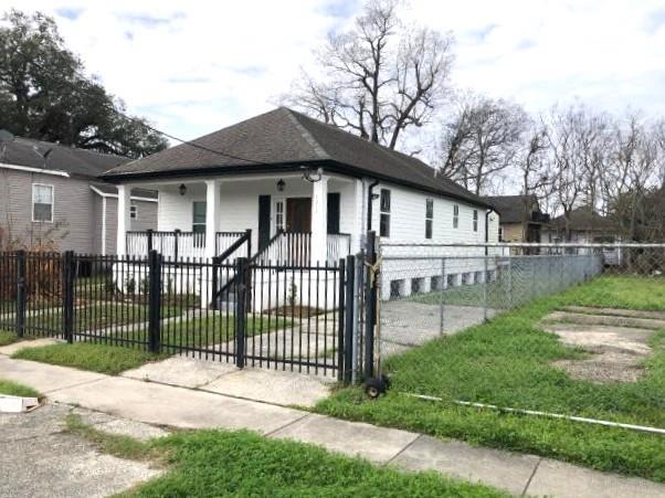 bungalow-style house with a fenced front yard and a gate