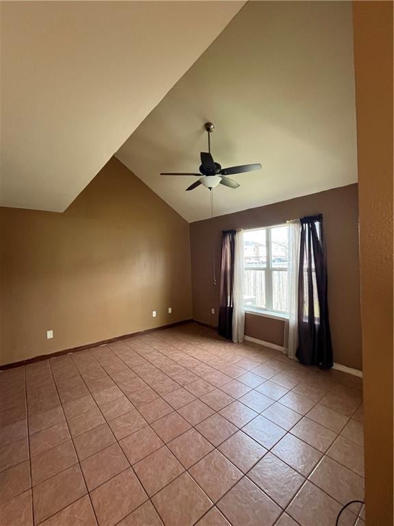 unfurnished room featuring light tile patterned floors, baseboards, vaulted ceiling, and a ceiling fan