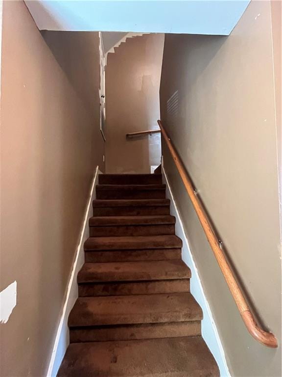 stairway featuring baseboards