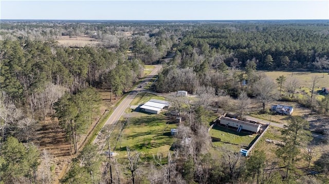 bird's eye view featuring a forest view and a rural view