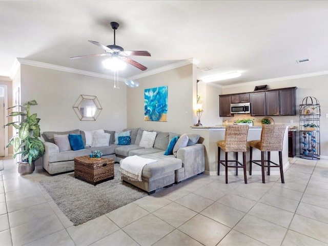 living room featuring visible vents, crown molding, and light tile patterned floors