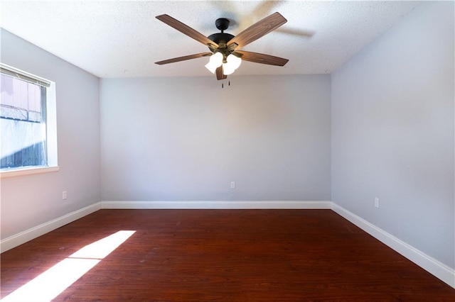 unfurnished room featuring ceiling fan, baseboards, and wood finished floors