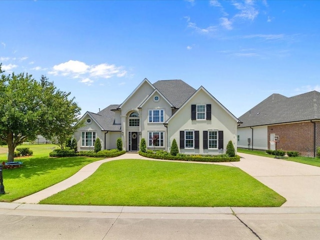 view of front of house featuring a front lawn and stucco siding