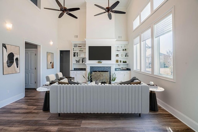 living room with dark wood-style flooring, radiator heating unit, a fireplace, and baseboards