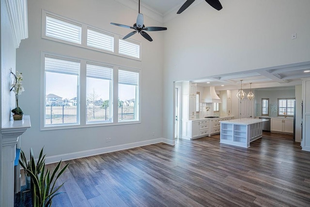 unfurnished living room with dark wood-style floors, beam ceiling, crown molding, coffered ceiling, and baseboards