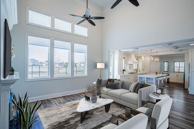 living area with ornamental molding, dark wood-style flooring, coffered ceiling, and baseboards