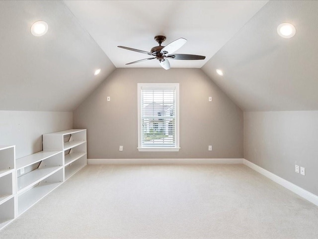 bonus room with light carpet, ceiling fan, baseboards, and lofted ceiling