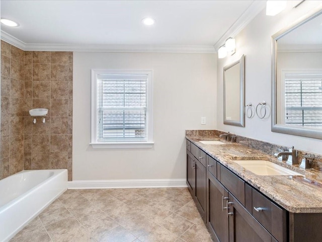 bathroom with ornamental molding, a sink, and baseboards