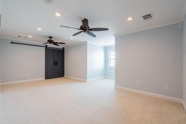 spare room featuring baseboards, ornamental molding, visible vents, and light colored carpet