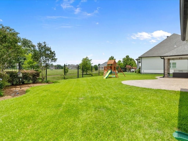 view of yard featuring a patio, central AC, a playground, and fence