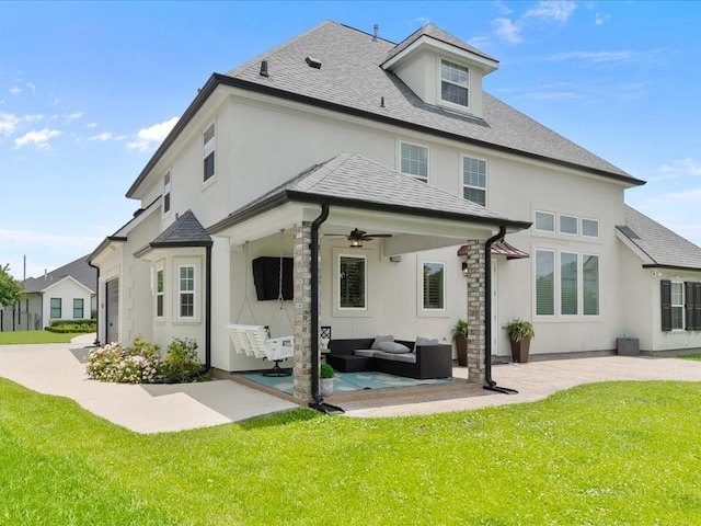 rear view of property featuring a patio, a yard, an outdoor living space, and stucco siding