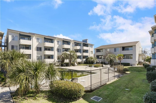 surrounding community featuring fence and a lawn