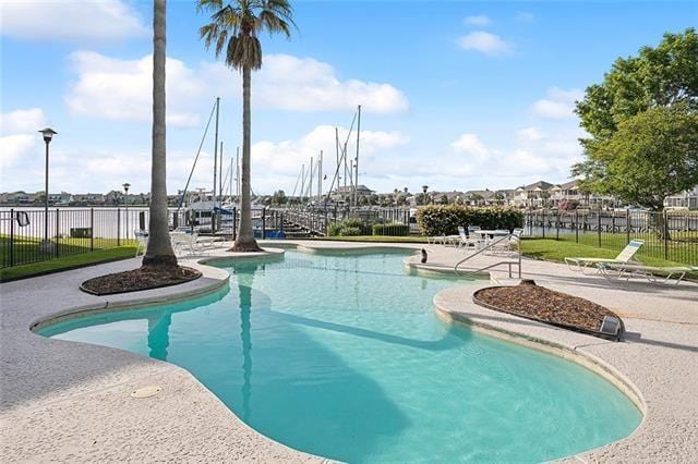 view of swimming pool with a patio area, fence, and a fenced in pool