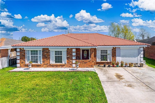 view of front facade featuring driveway, a garage, a tile roof, a front yard, and brick siding