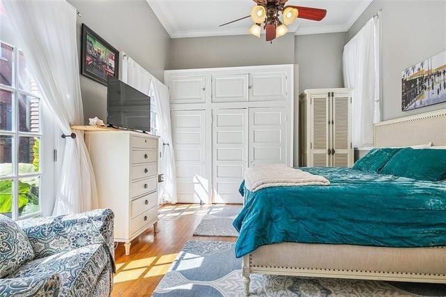 741 Esplanade Ave Unit 5, New Orleans, LA 70116 - bedroom featuring ornamental molding, light wood finished floors, a ceiling fan, and a closet