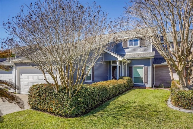 view of front of home with a garage, a front yard, and concrete driveway