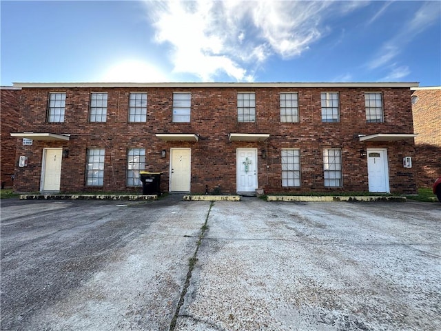 view of property featuring brick siding