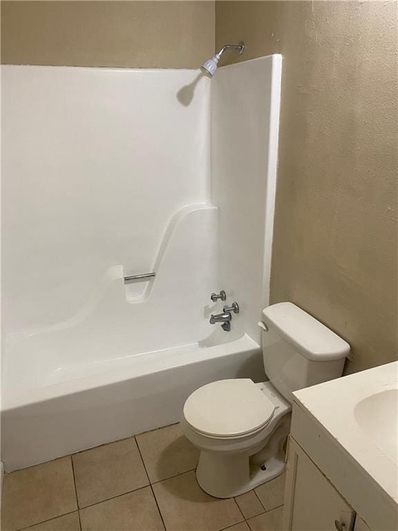 full bath featuring shower / bath combination, vanity, toilet, and tile patterned floors