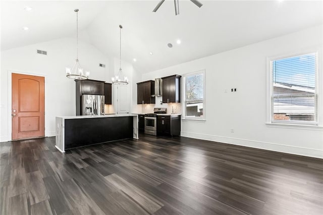 kitchen with stainless steel appliances, dark wood-type flooring, light countertops, and a wealth of natural light