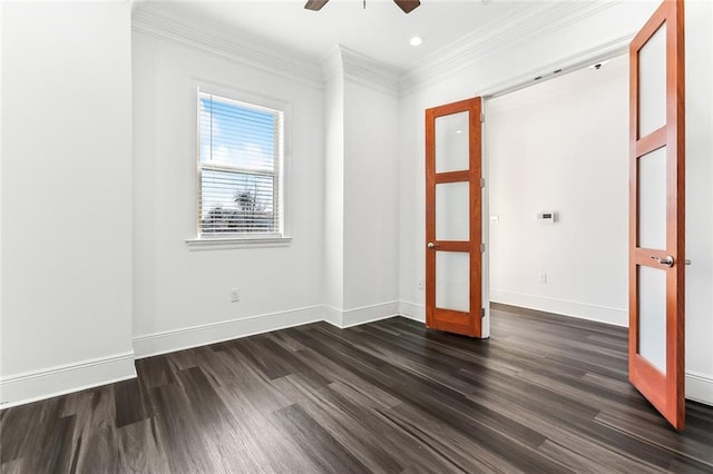 empty room with baseboards, dark wood-style flooring, crown molding, and french doors