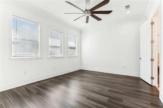 unfurnished room featuring dark wood-style floors, visible vents, ornamental molding, ceiling fan, and baseboards