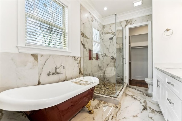 full bath featuring a marble finish shower, ornamental molding, marble finish floor, a freestanding bath, and vanity