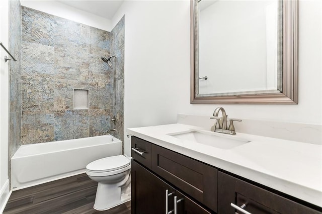 bathroom with toilet, shower / tub combination, wood finished floors, and vanity