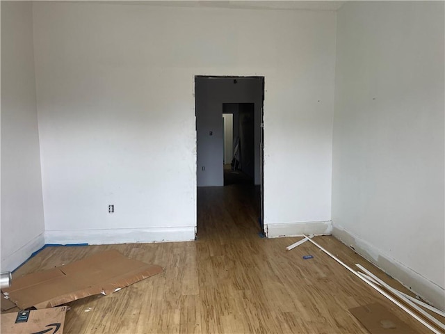 empty room with wood finished floors and baseboards