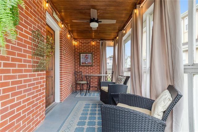 sunroom with wood ceiling and a ceiling fan