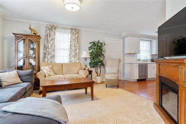 living room featuring ornamental molding and light wood-type flooring