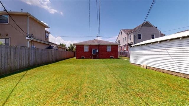 view of yard featuring fence and an outdoor structure