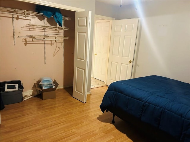 bedroom with a closet and light wood-style floors