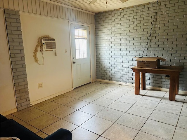 doorway to outside with a wall unit AC, light tile patterned floors, wood ceiling, ceiling fan, and brick wall